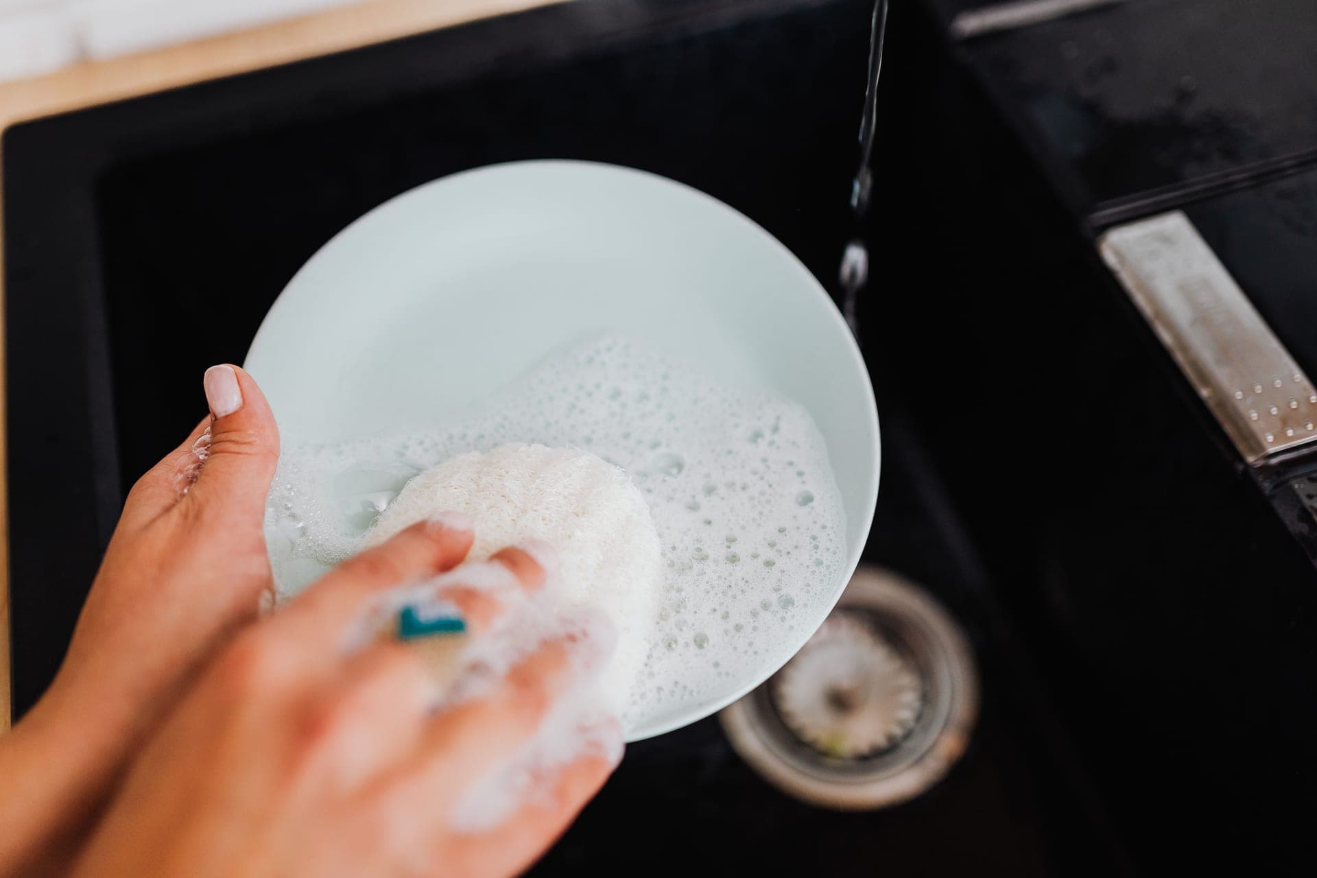 A textured scrub and a clear liquid in small dishes