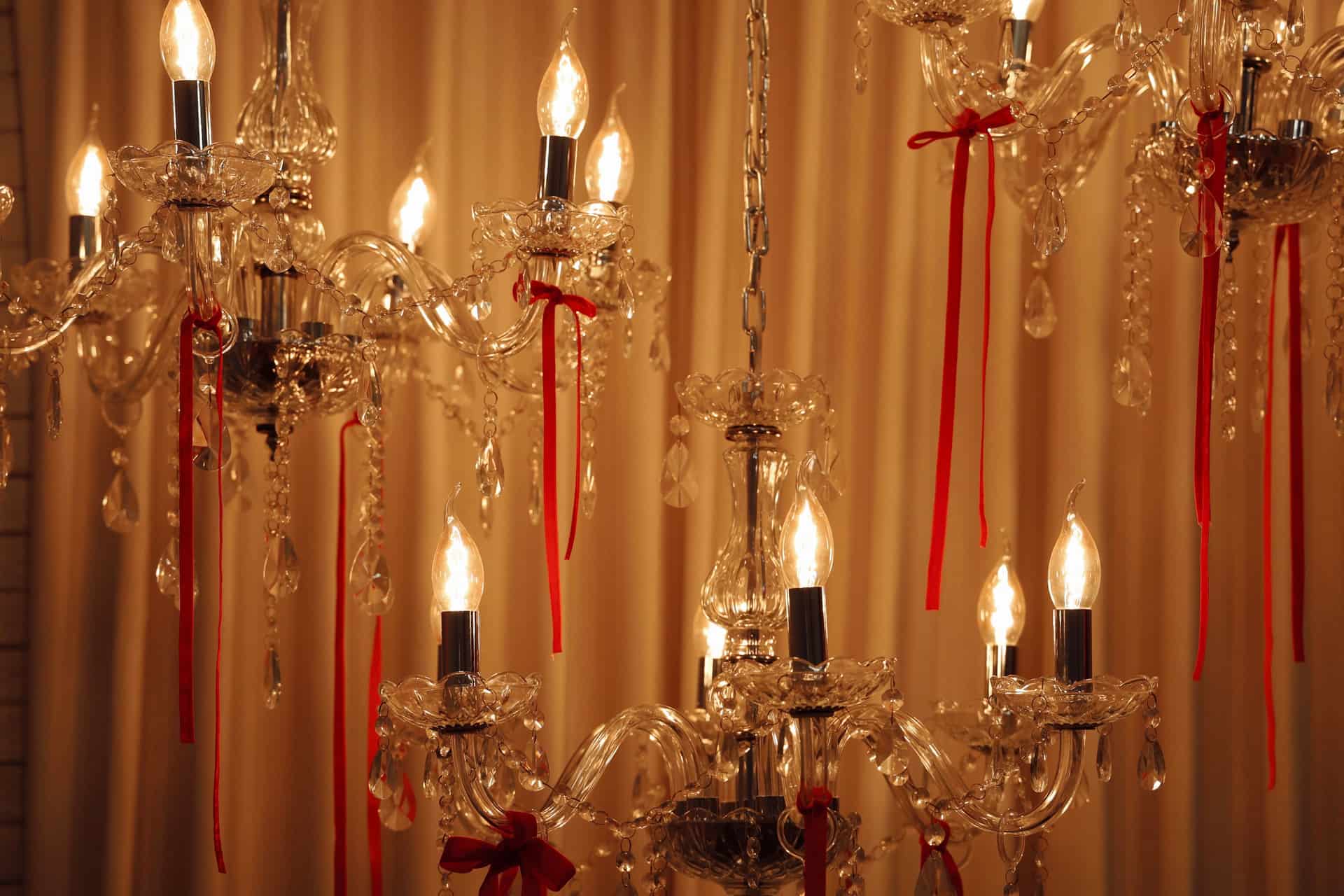 A crystal chandelier with red ribbons