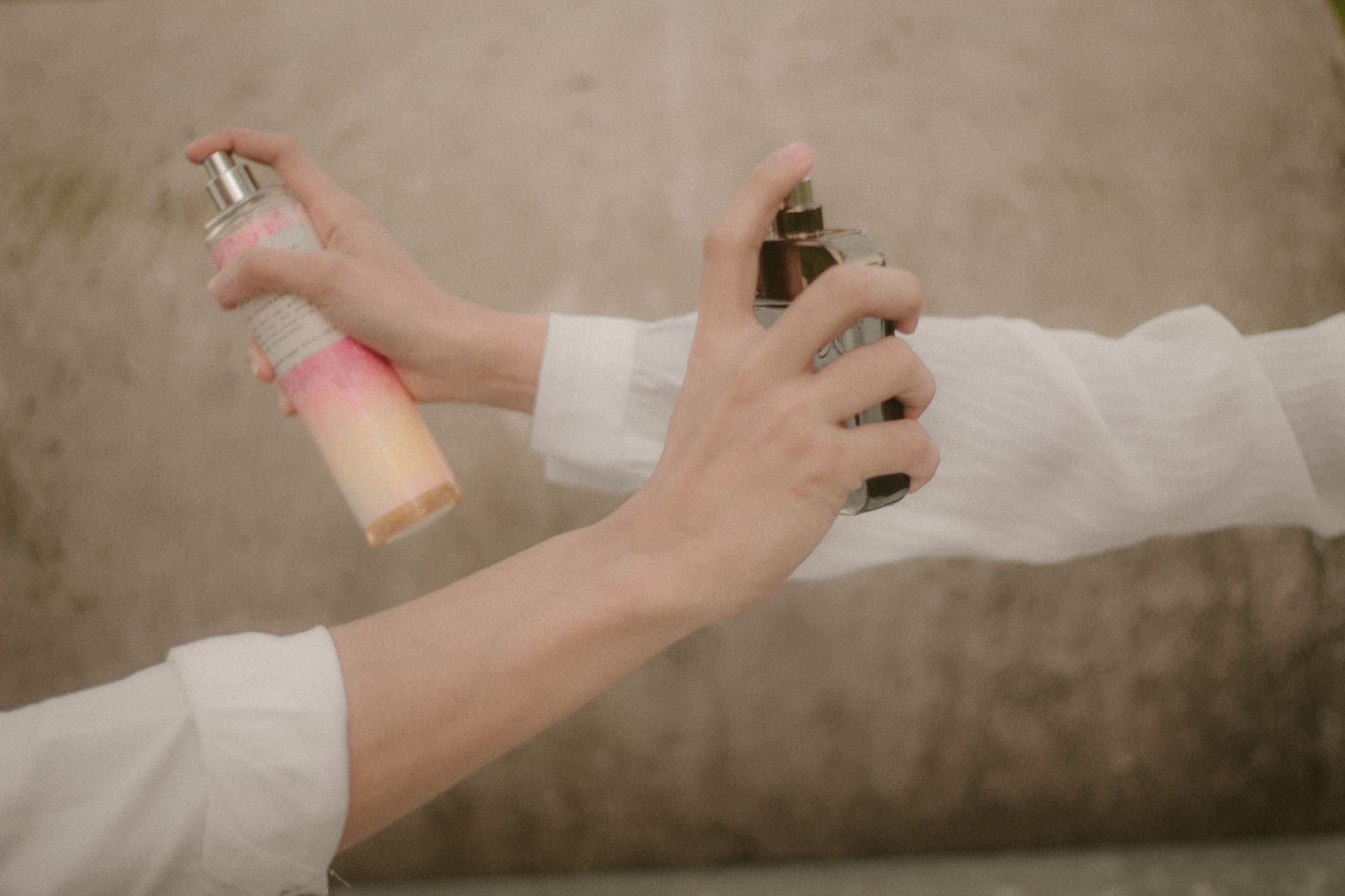 Two fragrance bottles side by side on a dark surface