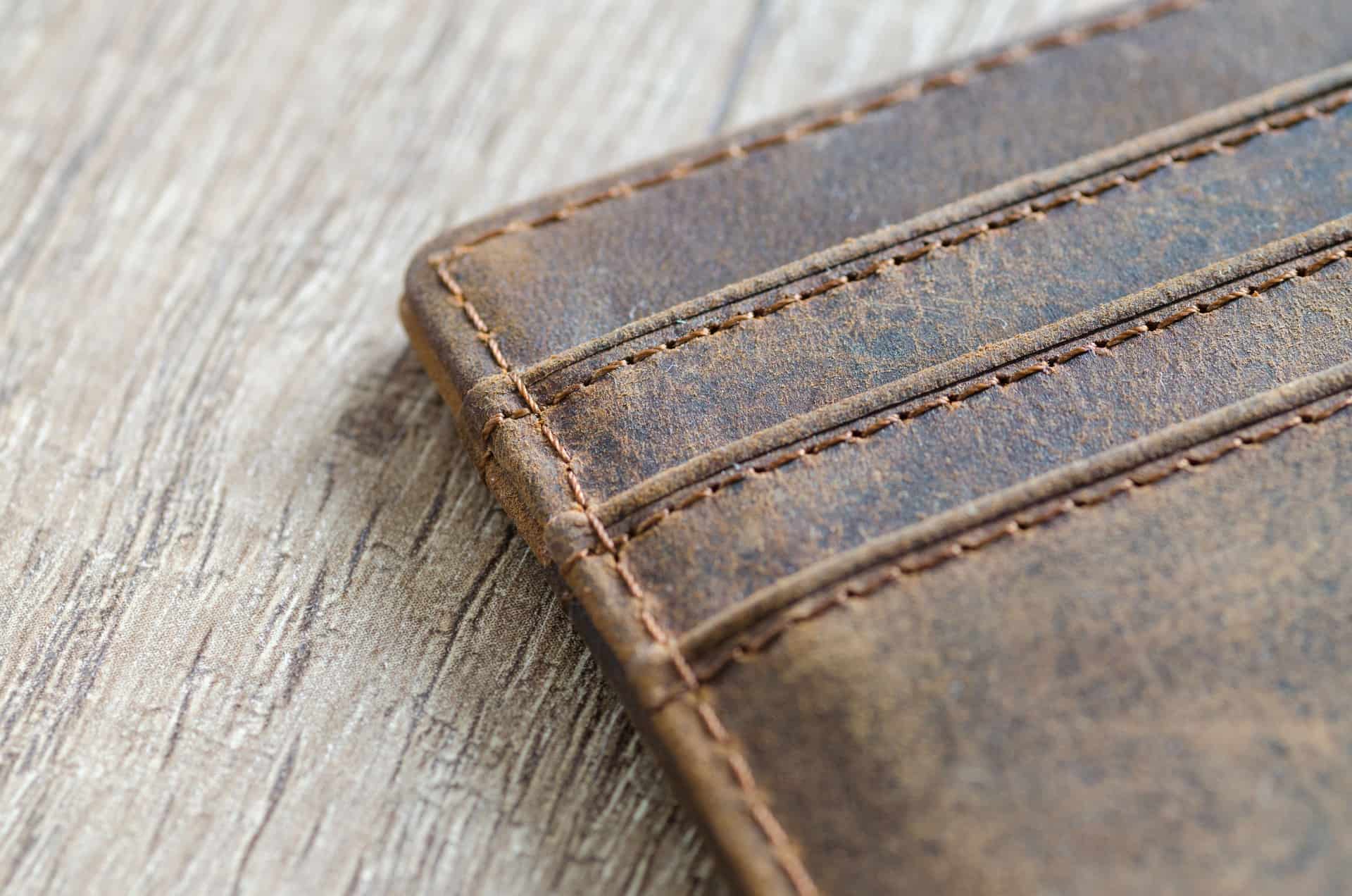 A worn brown leather wallet with visible stitching