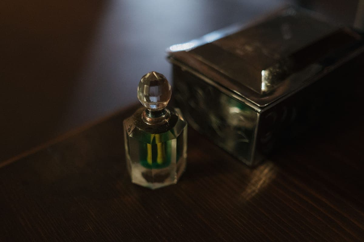 An artisan perfume bottle photographed in dark luxurious light
