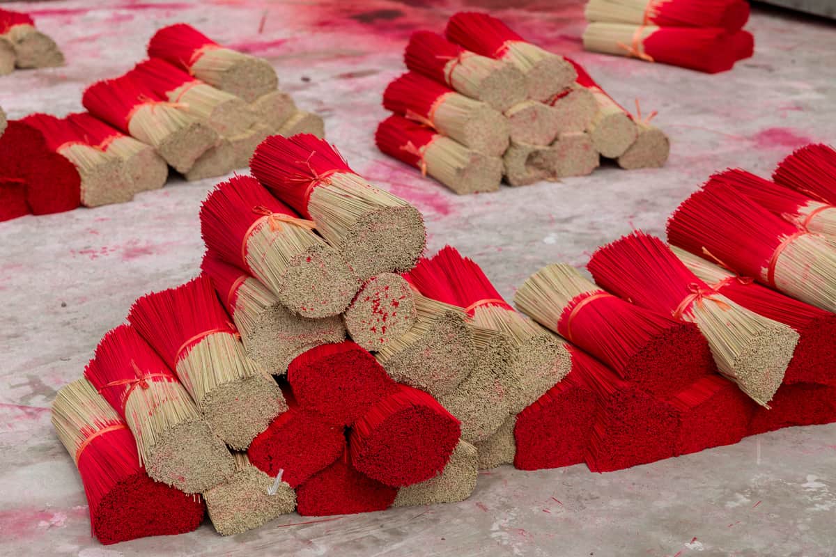 Sandalwood powder and sticks arranged on a dark surface