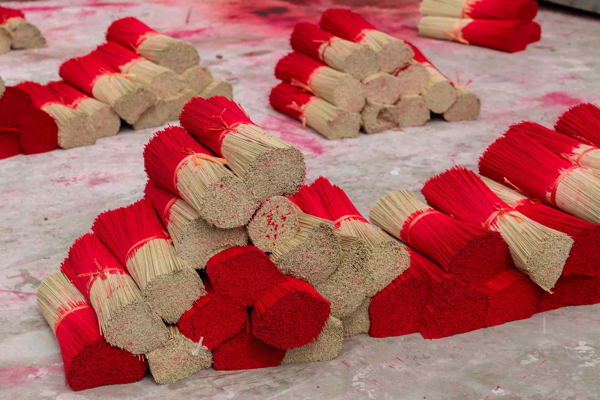 Bundles of red-tipped incense sticks