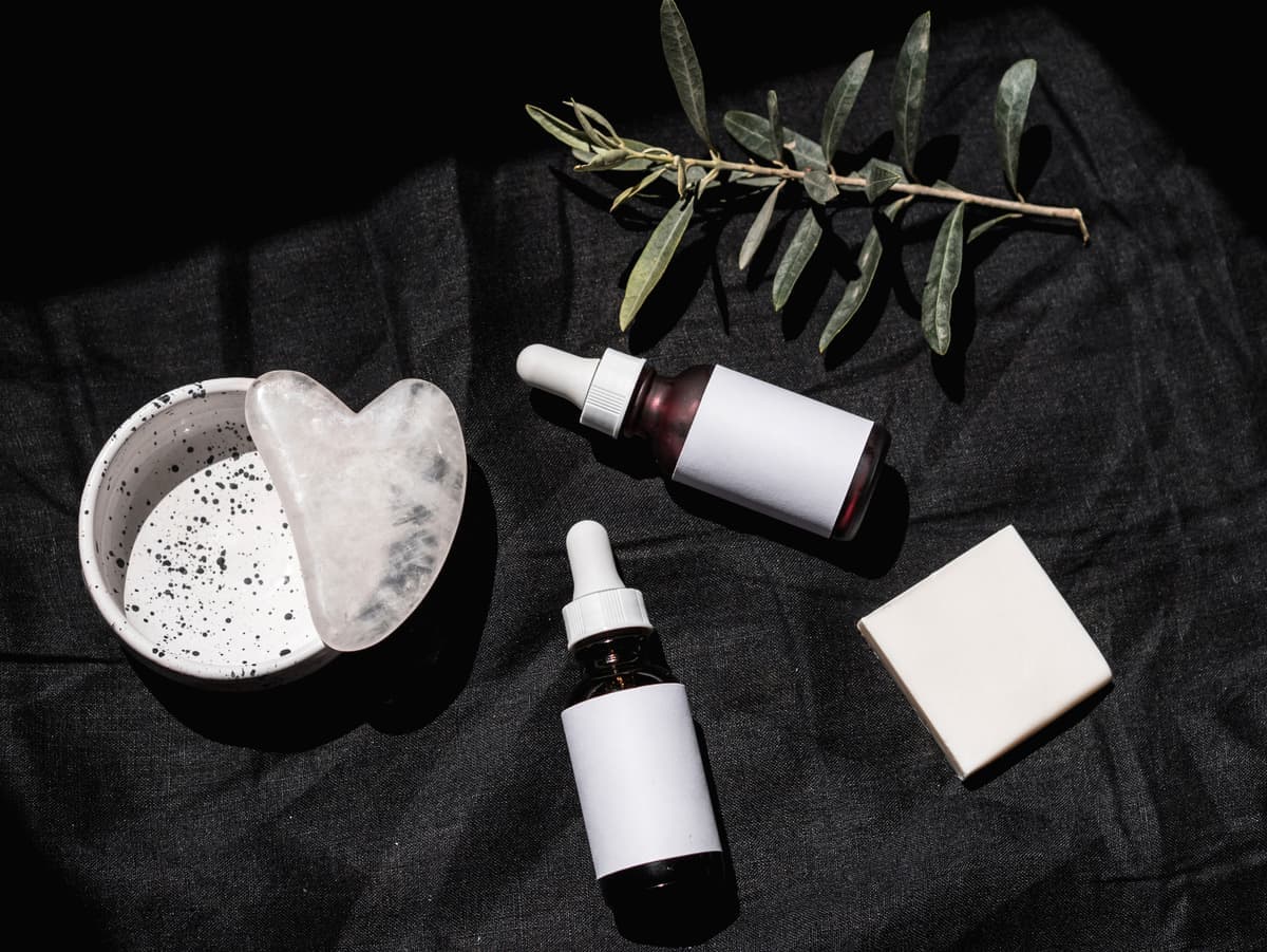 A small set of skincare essentials on a dark surface