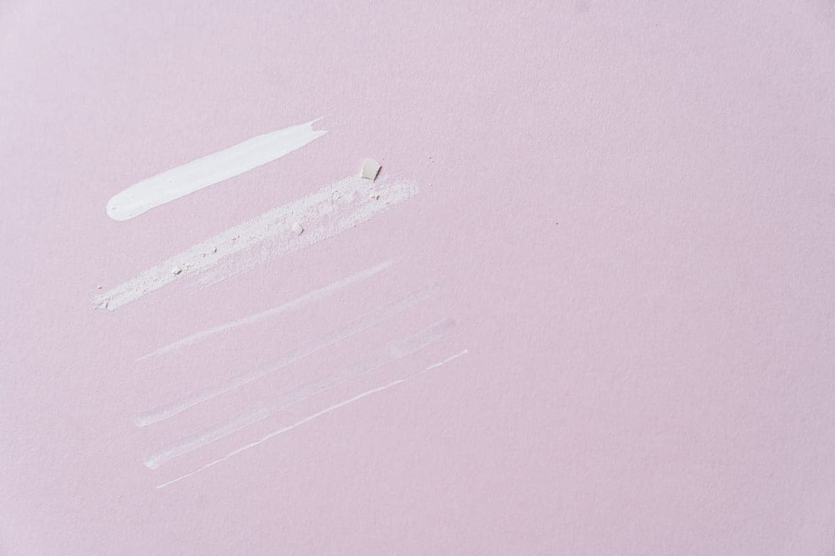 A swatch of rich moisturizer on a dark stone surface