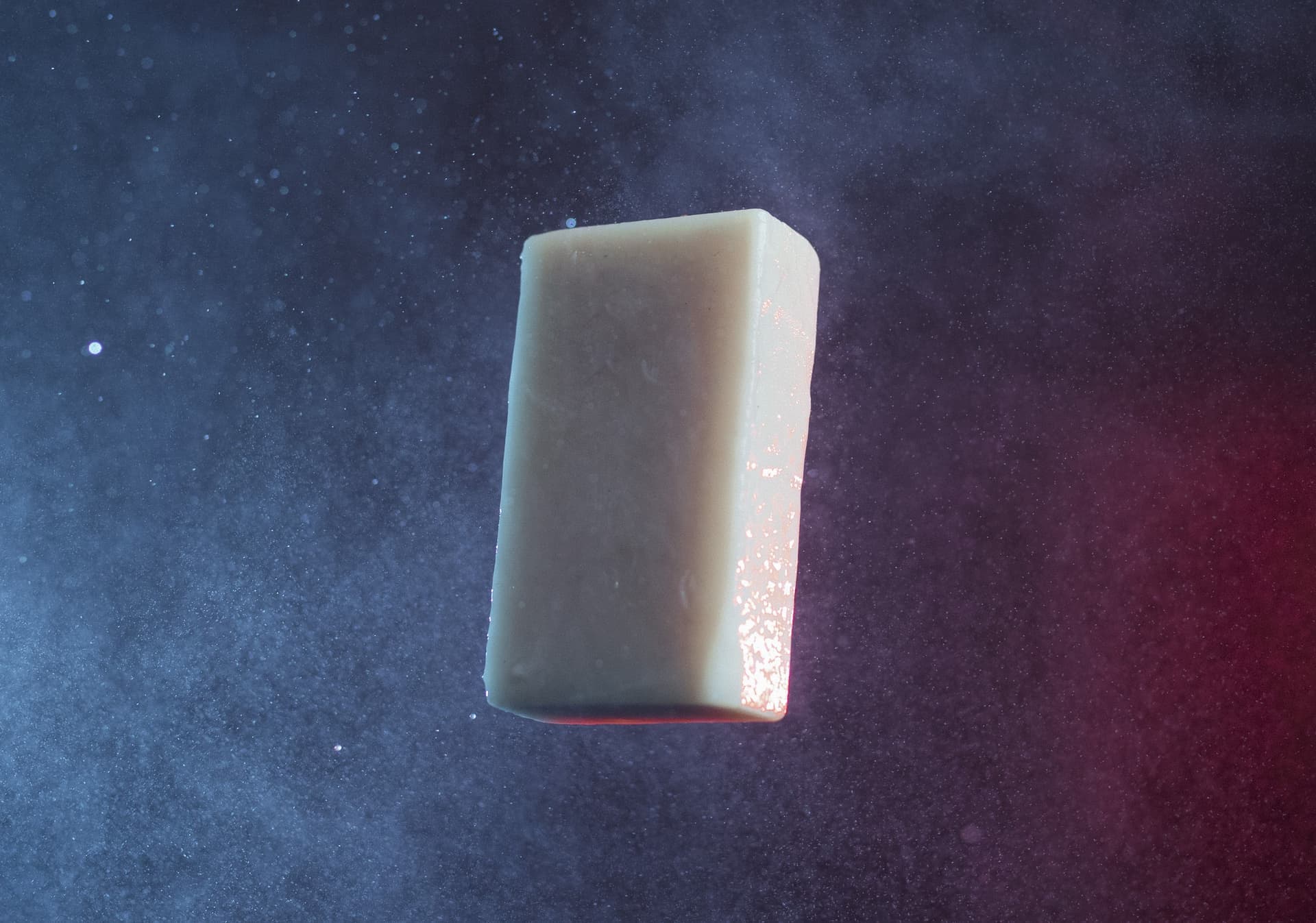 A bar of soap lit against a dark background