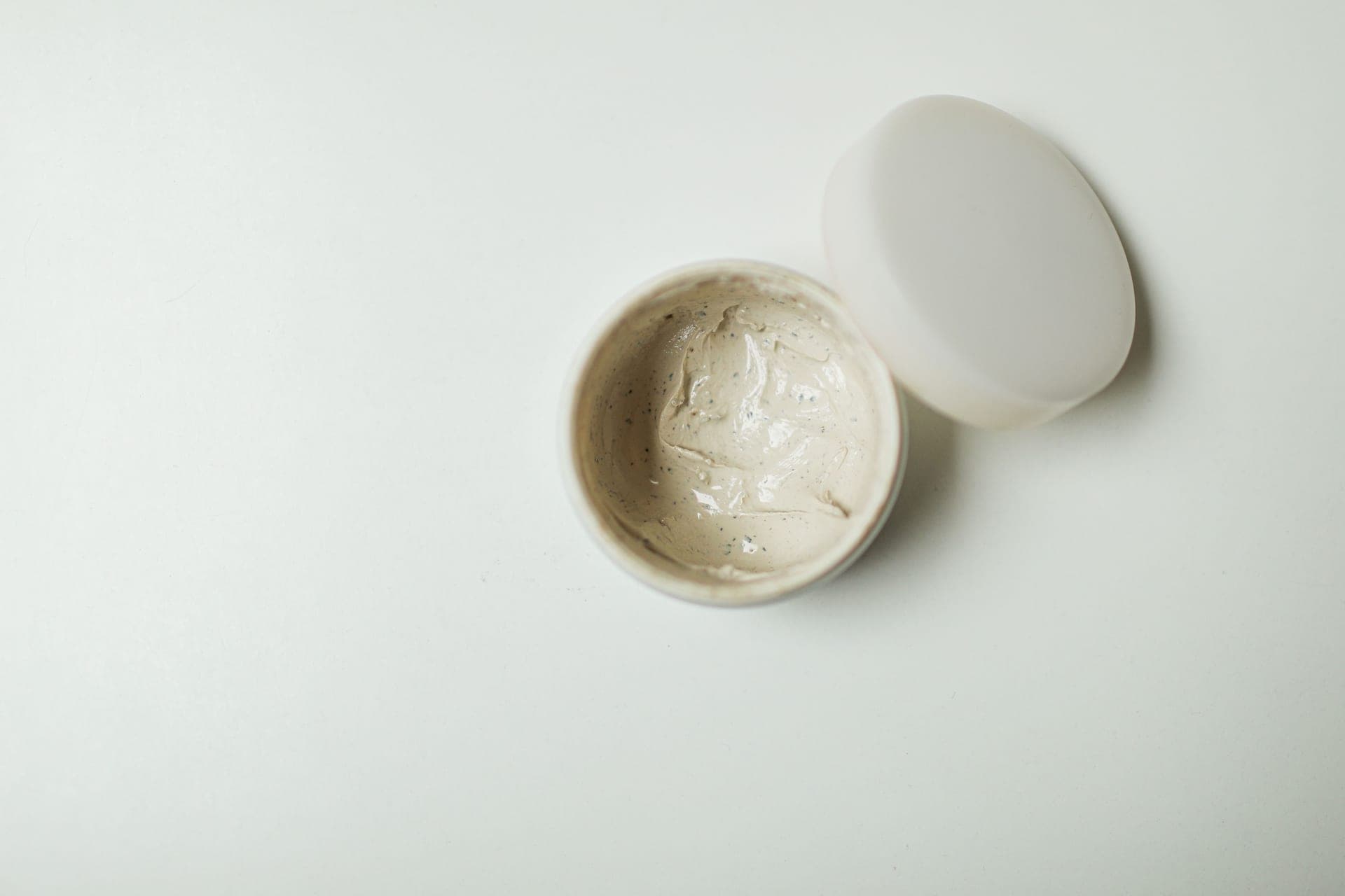 A white cream swatched on a pale surface