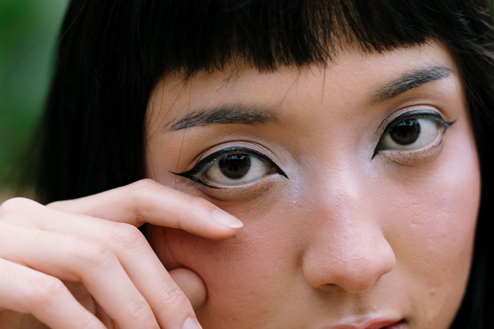 A close-up of a face with bold eye makeup