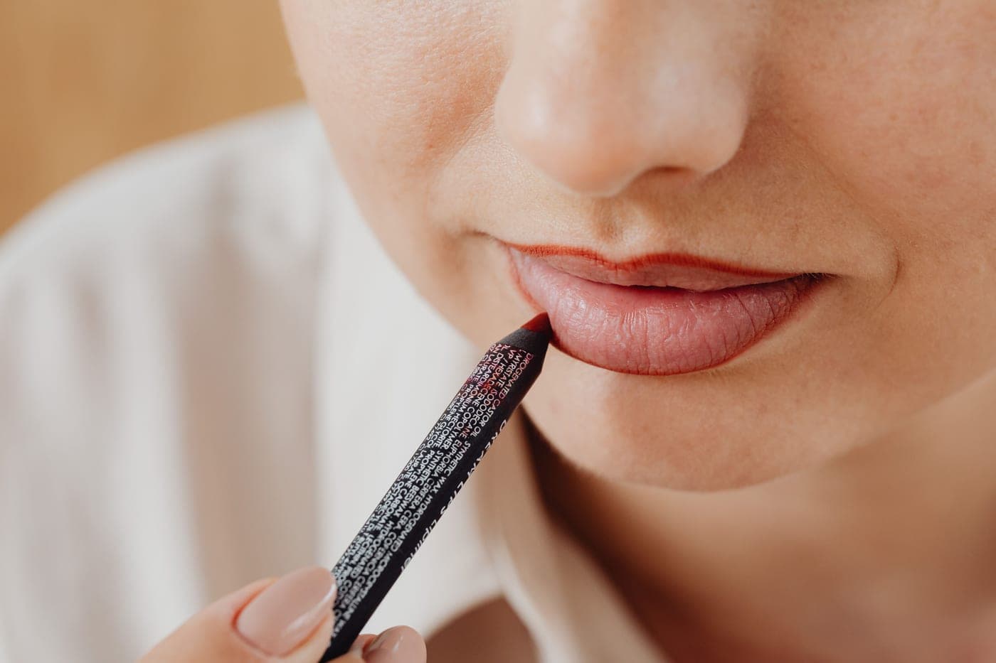 A lip pencil being applied to the lip line