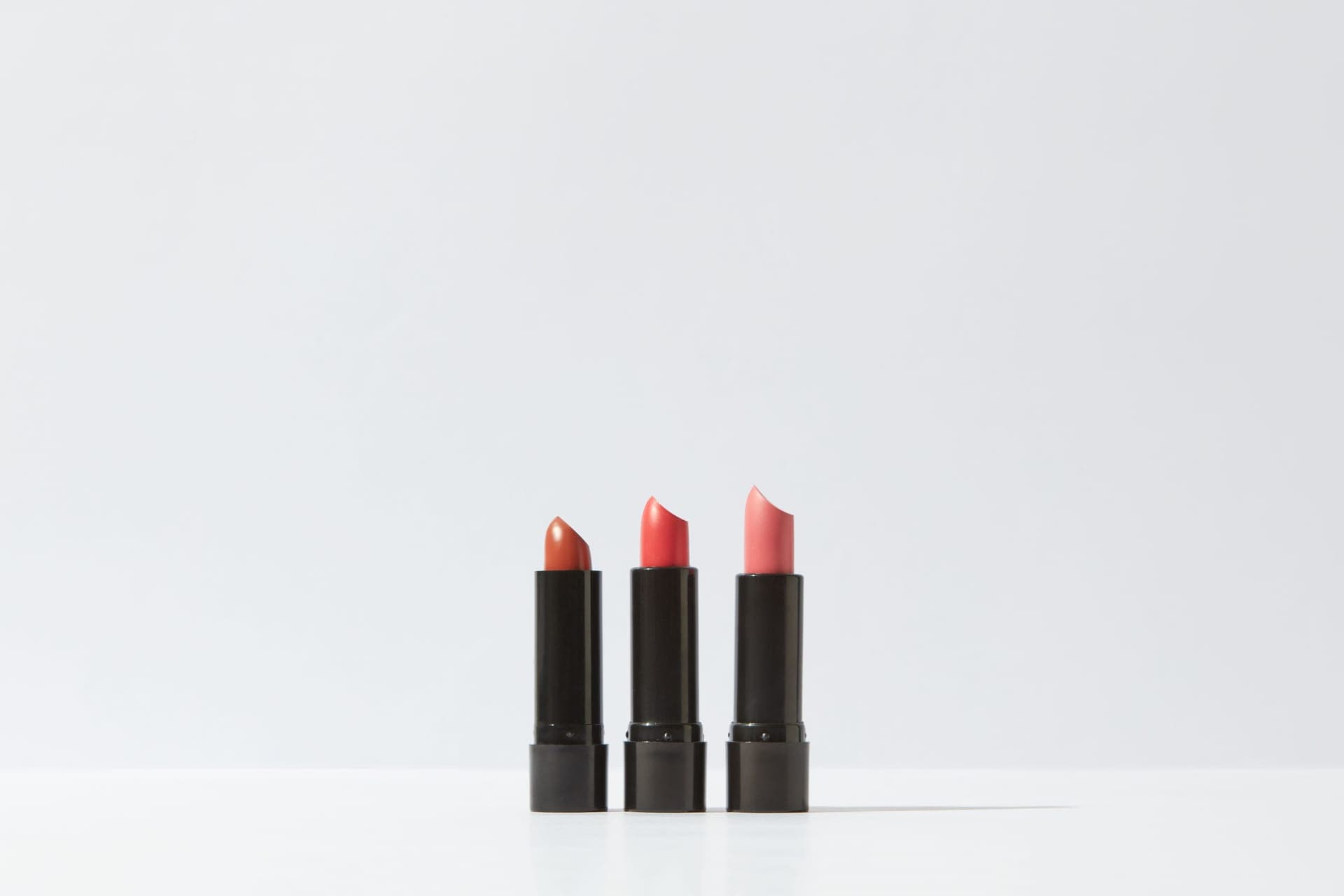 Lipstick bullets arranged on a dark surface