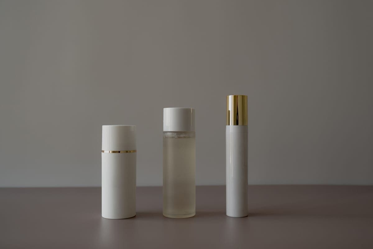 A body lotion bottle on a dark minimal surface