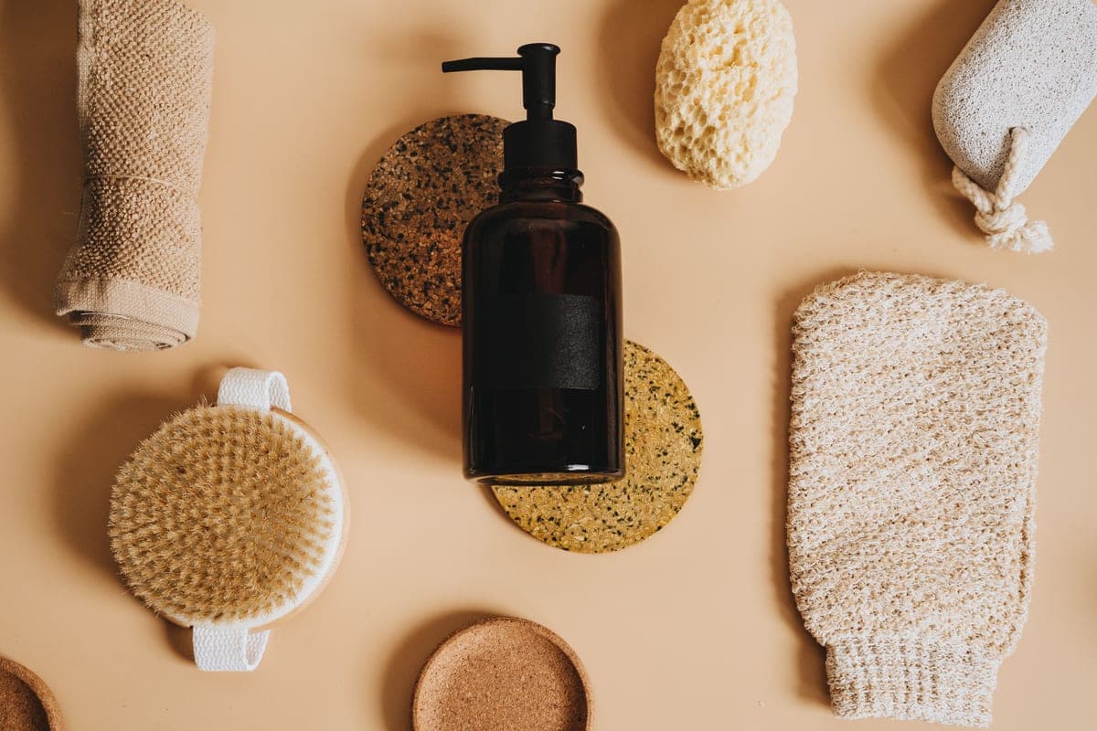 A glass bottle of exfoliating liquid on dark stone