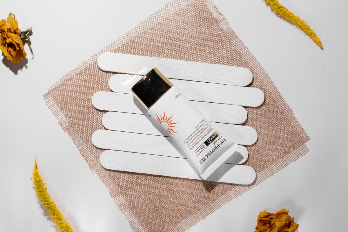 A sunscreen bottle standing on a dark minimal surface