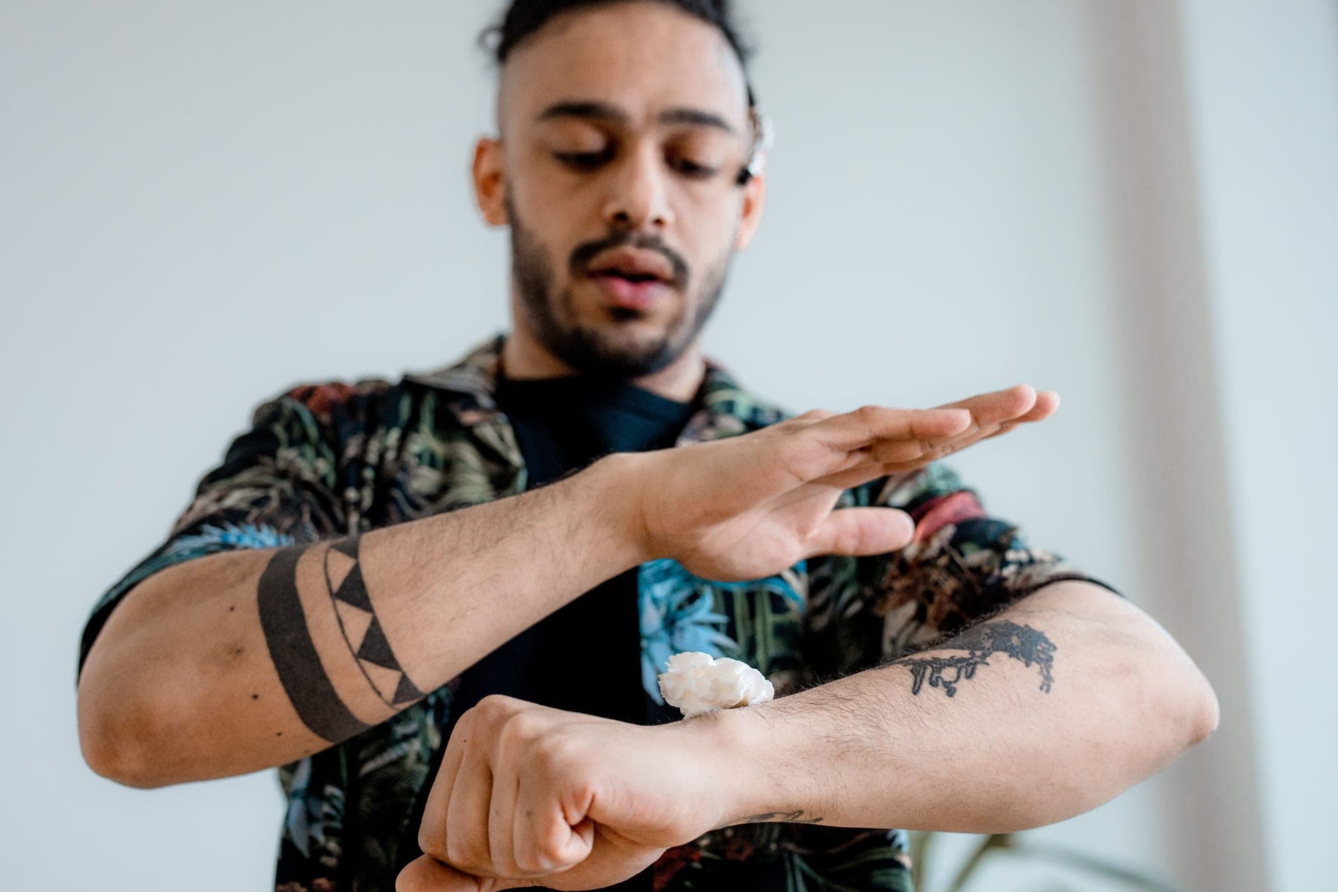 A man applying cream to his forearm