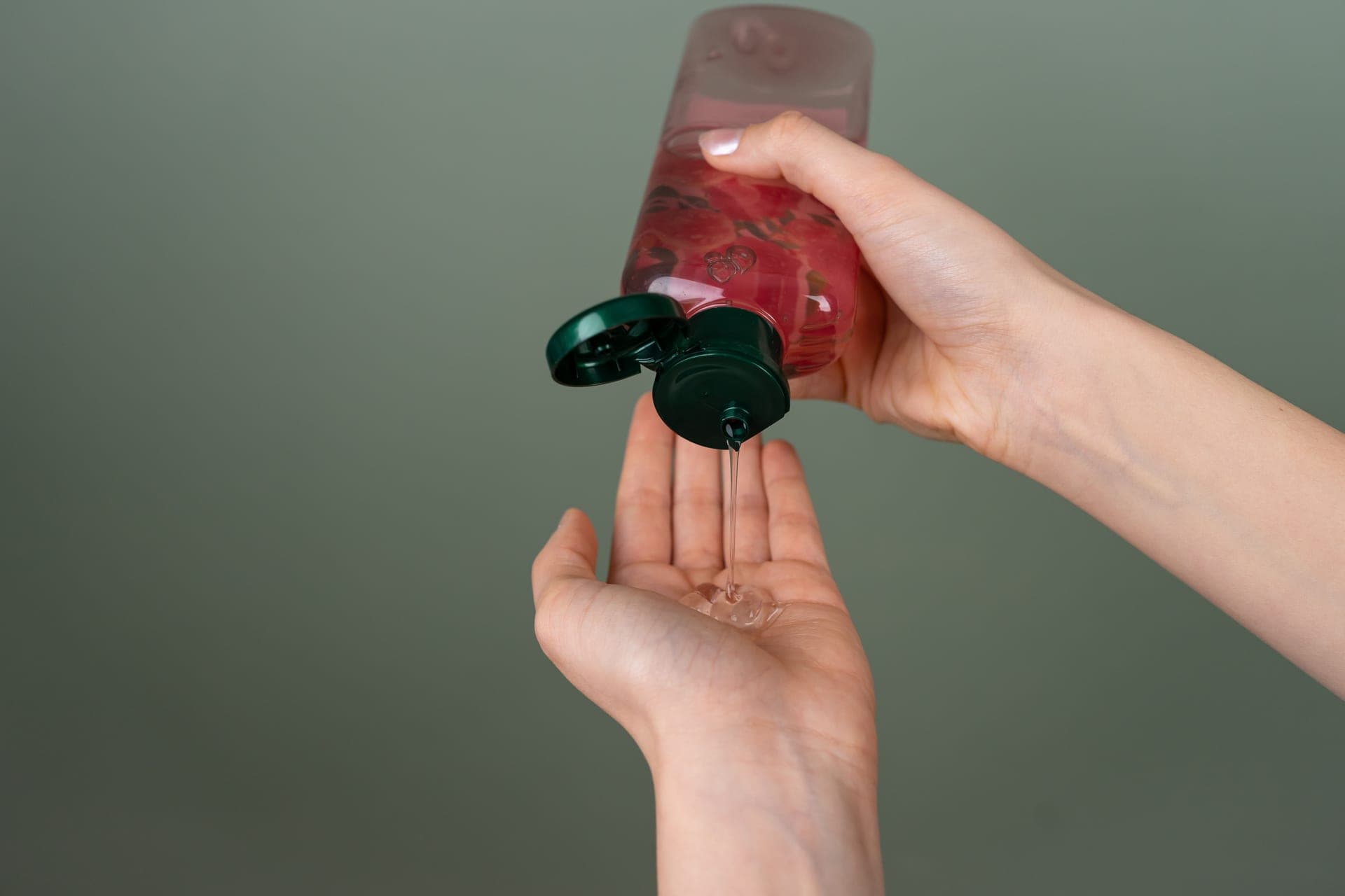 Liquid being poured from a bottle into a palm