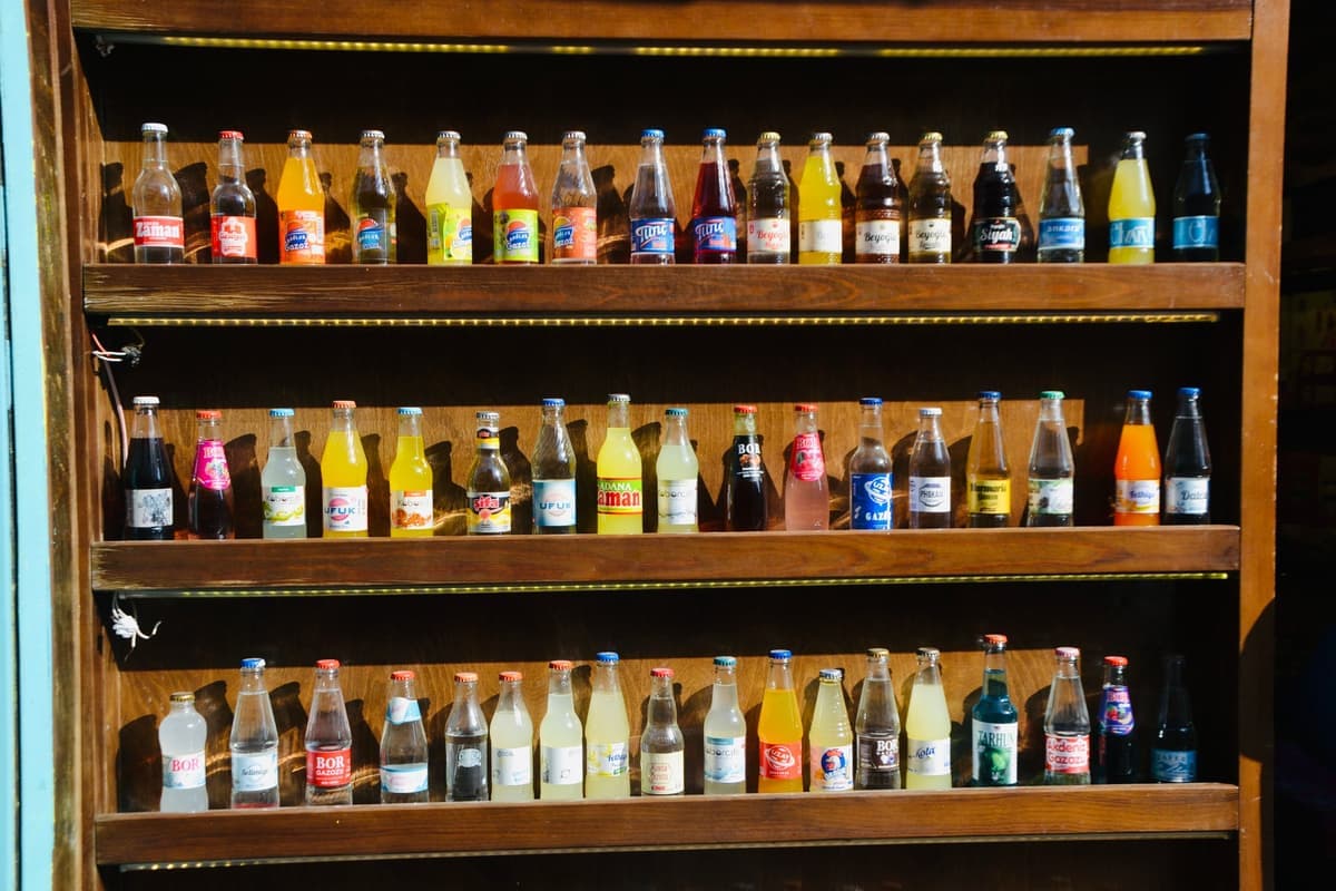 A collection of glass bottles on a dark shelf