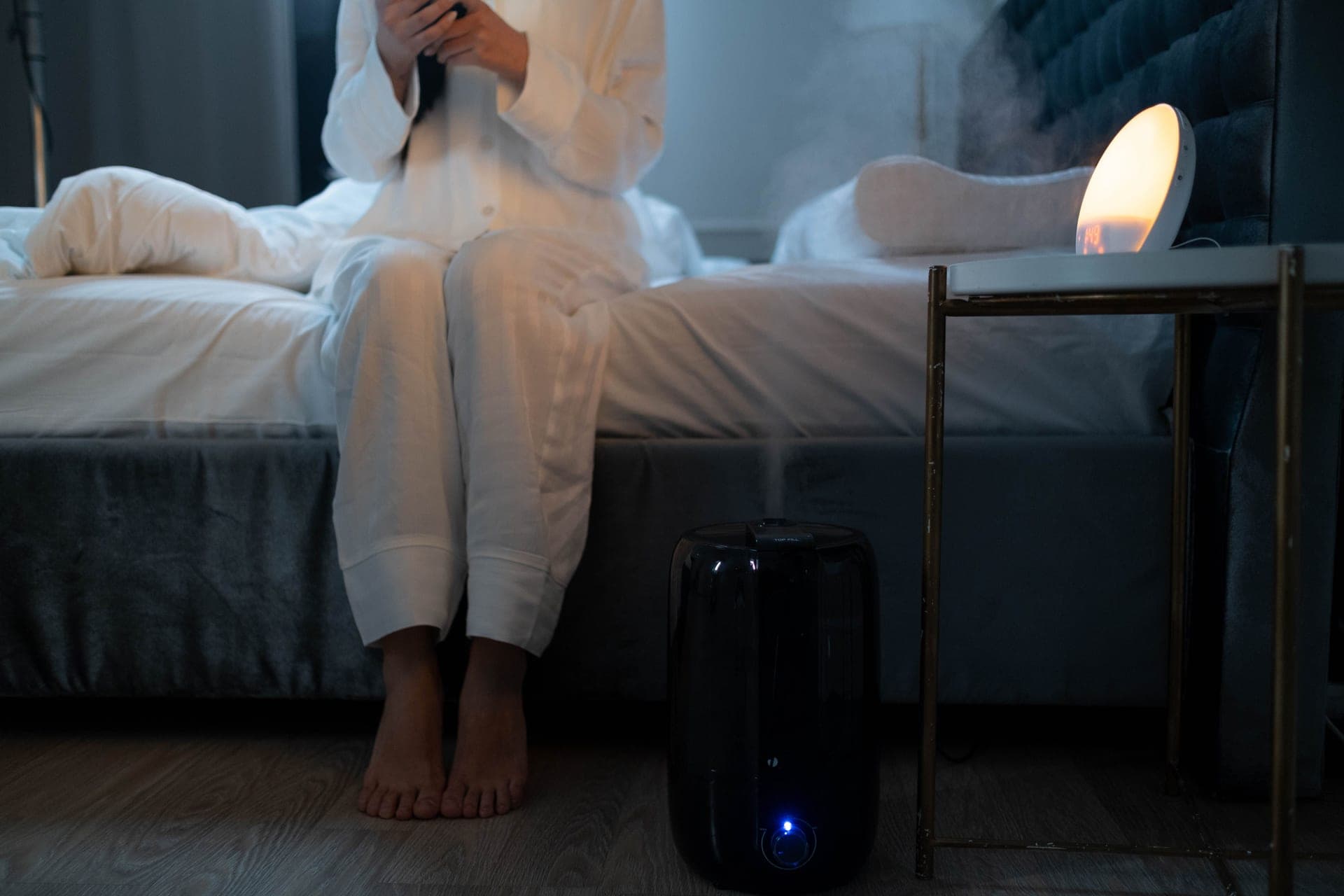 Humidifier mist in a softly lit bedroom