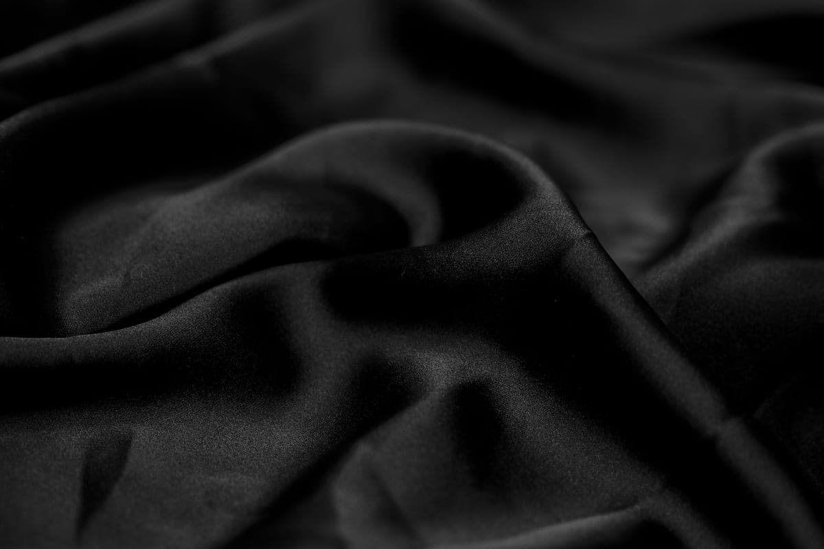 Silk fabric draped over a pillow in low light